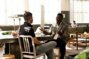 Two adults engaged in work conversation or interview